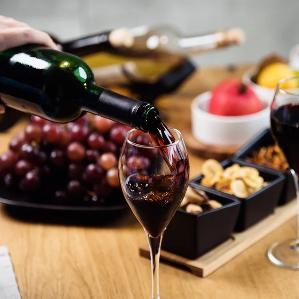 Woman pouring red wine in restaurant