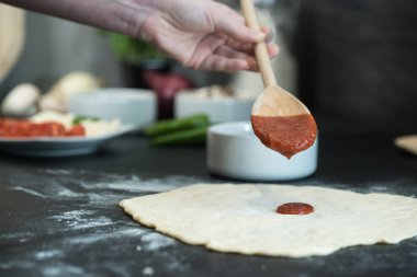 Evde pizza hazırlayan kadın.