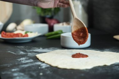 Evde pizza hazırlayan kadın.