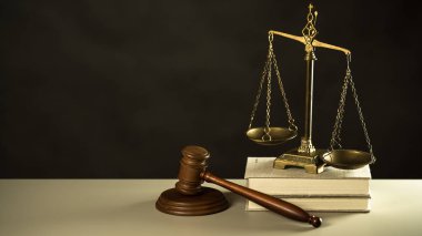 Law and Justice symbols on wooden table with blurred books background. clipart