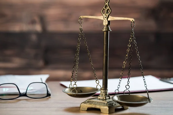 Still life of Law and Justice - scales with books on wooden table.