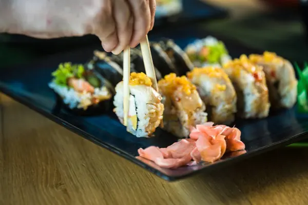 Person Eating Fresh Japanese Sushi Rolls Popular Asian Food — Stock Photo, Image