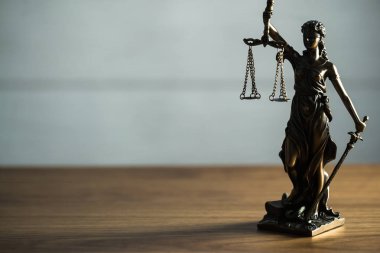 Masanın üzerinde Adalet ve Hukuk sembolü ve terazili Kör Tanrıça Themis 'in hayatı
