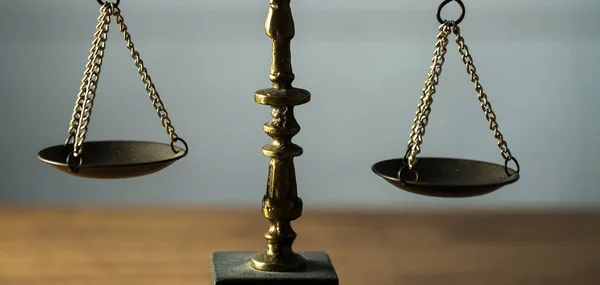 Still life of Law and Justice - scales on wooden table background.