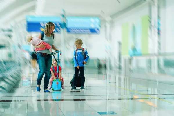 Мать и дети прогулки в аэропорту — стоковое фото