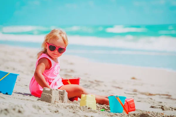 Bonito menina jogar com areia na praia — Fotografia de Stock