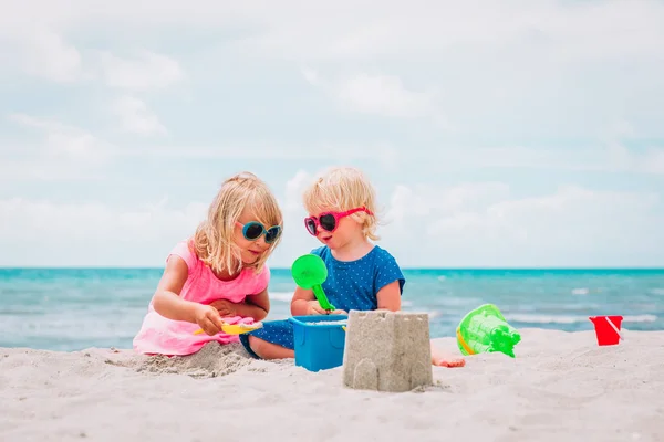 Çocuklar yaz plajında kumla oynarlar. — Stok fotoğraf