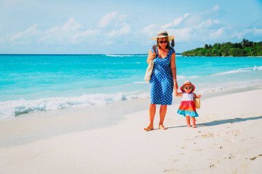 Anne ve sevimli küçük kız Sahilde yürüyüş