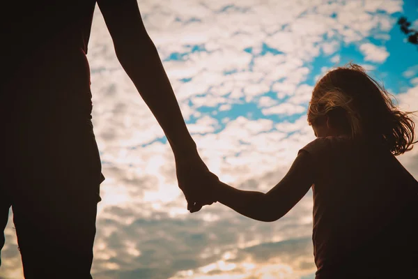 Parenting -mother and daughter holding hands at sunset — Stock Photo, Image