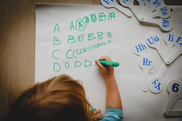 Little girl learning to write letters, education — Stock Photo, Image