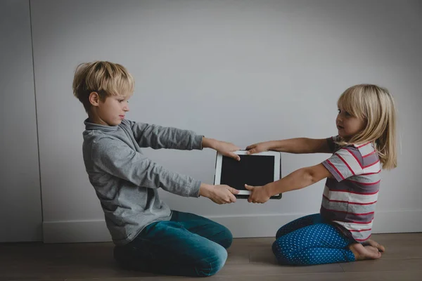 Kleine Jungen und Mädchen kämpfen gegen Touchpad, Computersucht — Stockfoto