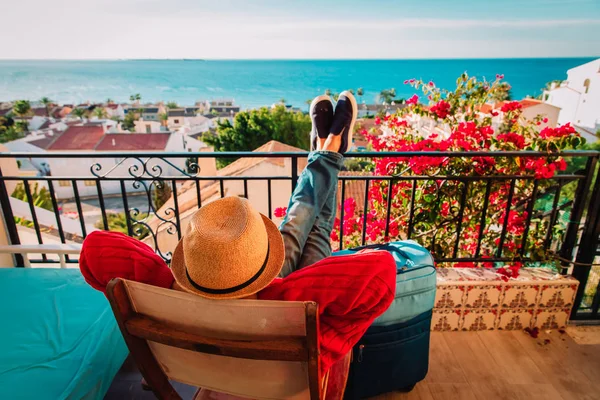Joven relajarse en la terraza del balcón con maleta, concepto de viaje — Foto de Stock