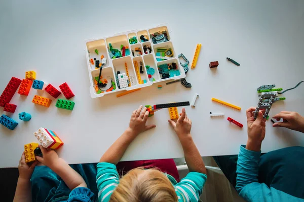 Crianças brincam com blocos de plástico, construindo robô na lição da escola — Fotografia de Stock