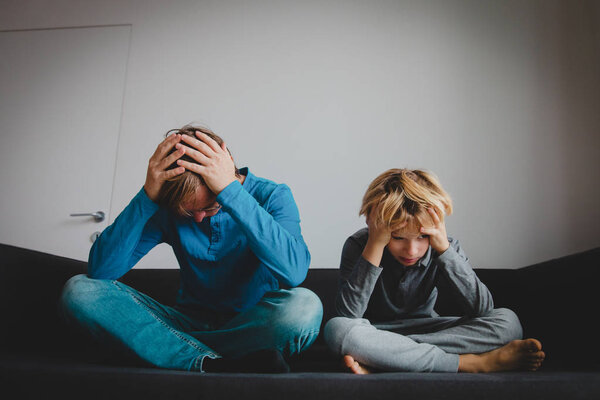 sad child with stressed father, family problems, sorrow