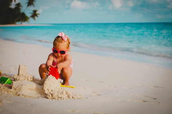 Carino bambina giocare con sabbia sulla spiaggia — Foto Stock