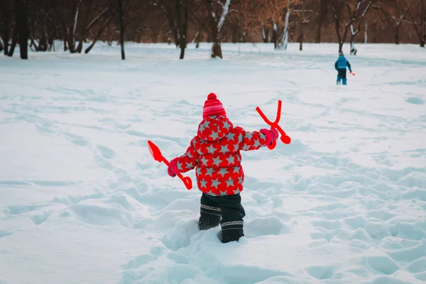 Μικρό κορίτσι και αγόρι πάνε να παίξουν με το χιόνι το χειμώνα — Φωτογραφία Αρχείου