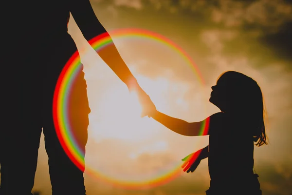 Silhouette Little Girl Holding Parent Hand Sunset Sky — стоковое фото