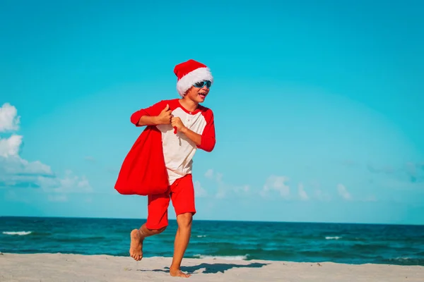 Little boy play santa on tropical beach at christmas — Stock Photo, Image