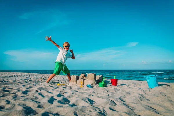 Ευτυχισμένος μικρό αγόρι χτισμένο κάστρο με άμμο τροπική παραλία — Φωτογραφία Αρχείου