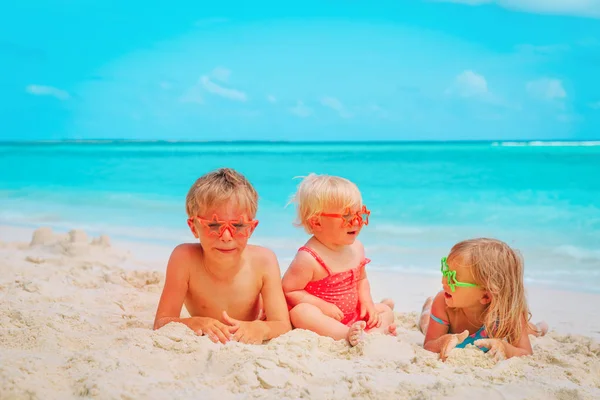 Carino bambino e ragazze giocare con sabbia sulla spiaggia — Foto Stock