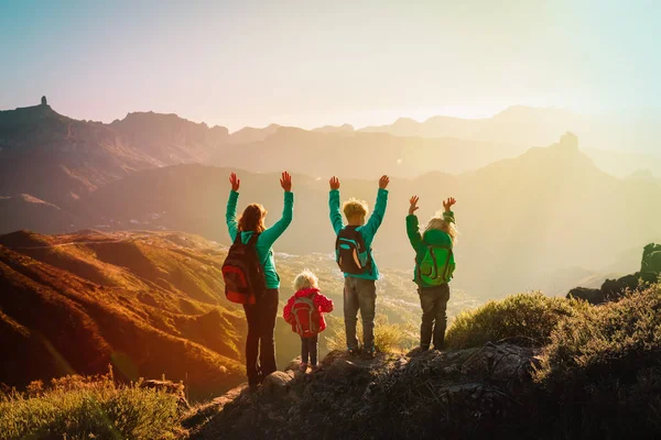 Счастливое семейное путешествие в горах на закате, мама с детьми наслаждаются походами — стоковое фото
