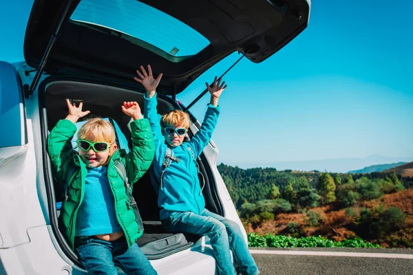 happy boy and girl enjoy travel by car, family vacation