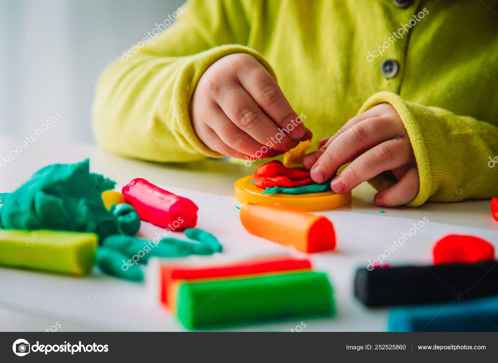Child playing with clay molding shapes, kids crafts Stock Photo by