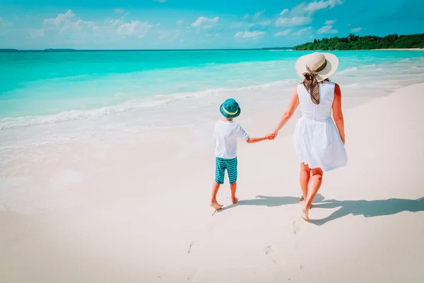 Madre e hijo caminan en la playa tropical — Foto de Stock