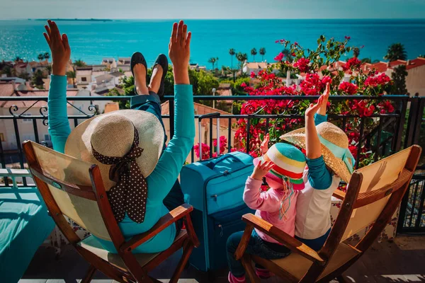 Glückliche Mutter und Kinder entspannen auf der Balkonterrasse mit Koffern — Stockfoto