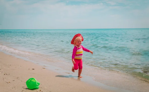 Bambina giocare con l'acqua in vacanza al mare — Foto Stock