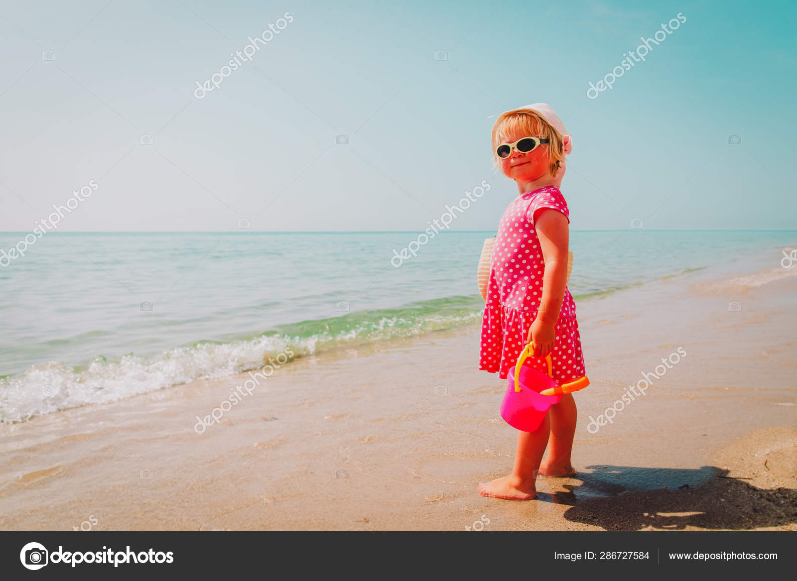 icdn.ru cute girl Cute little girl play with sand on beach — Stock Photo © Nadezhda1906  #286727584