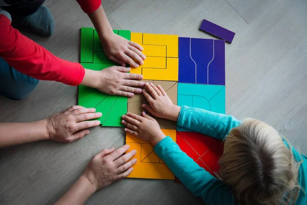 Professor e crianças brincam com quebra-cabeça, fazendo tangram — Fotografia de Stock