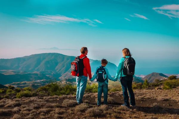 happy family-mom, dad and son-travel in nature