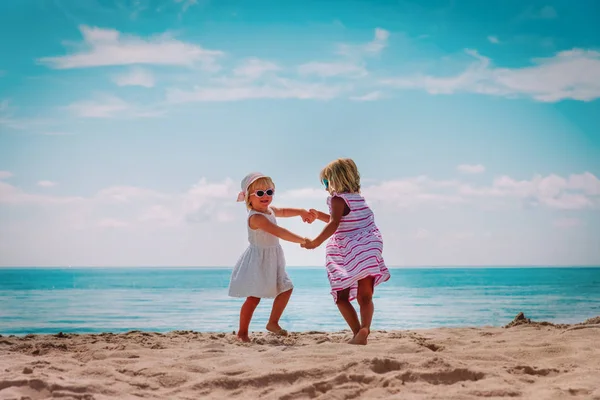 Schattige kleine meisjes dansen spelen op Summer Beach — Stockfoto