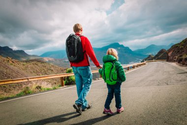 Baba küçük kızı dağlarda yolda yürüme ile