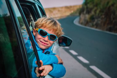 Mutlu çocuk arabayla seyahat etmeyi, dağlarda seyahat etmeyi, aile tatilini sever.