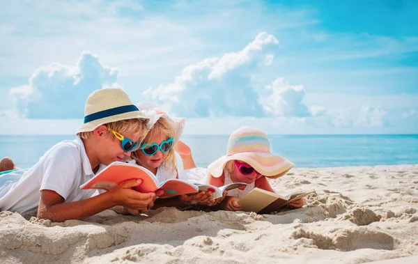 Bambini-ragazzo felice e ragazze- leggere libri sulla spiaggia, lettura estiva in vacanza — Foto Stock