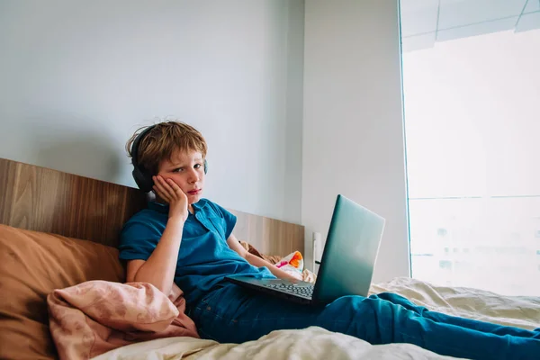 Bored and tired boy with a laptop, distant remote education during quarantine — Zdjęcie stockowe