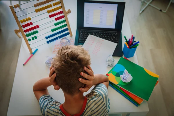 kid tired and stressed by doing homework