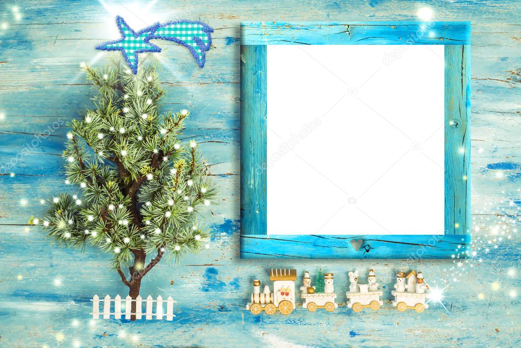 Christmas Nativity photo frame greetings. Christmas tree and vintage style wooden train with empty photo frame to put photo or message