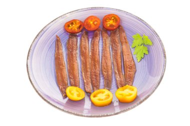 Plate of salted anchovies isolated. clipart