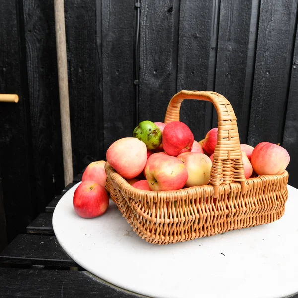 Autumn apples in a wicker basket stock photo — Stock Photo, Image