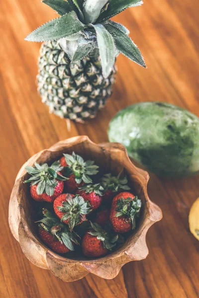 Strawberries in a wooden teak bowl. Indonesian teak wooden bowl.