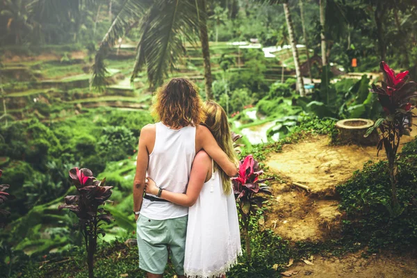 Young honeymoon couple on rice fields of Bali island. Travel vacation on Bali concept.