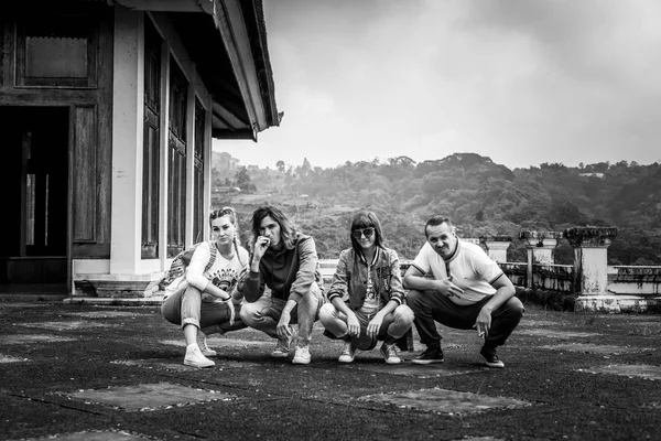 Group of tourists in abandoned hotel on the north of Bali island, Indonesia. Funny black and white picture.