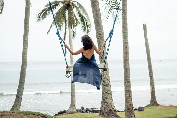Woman swings on a tropical beach of Bali island, Indonesia. — Stock Photo, Image