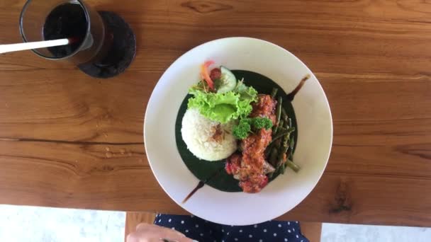 Mulher comendo bife de atum em um café tropical da ilha de Bali, Indonésia . — Vídeo de Stock