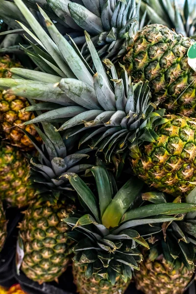 Pile pineapple fruit which has been harvested and display for sale on farmers table in market. — Stock Photo, Image