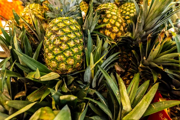 Pile pineapple fruit which has been harvested and display for sale on farmers table in market. — Stock Photo, Image