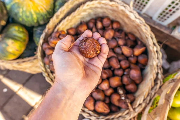 Snake fruit Salacca on sale on a local organic food and fruits market. Bali island.